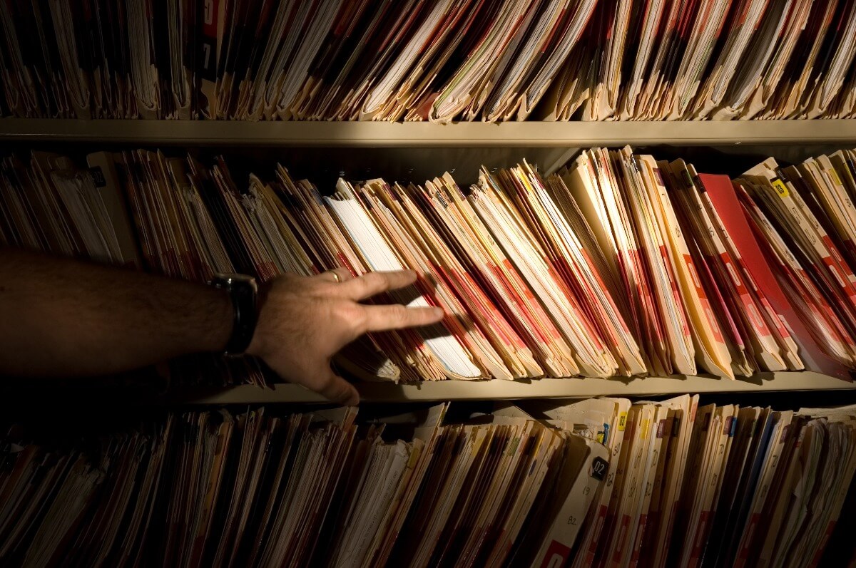 photo of patient records and suspicious hand
